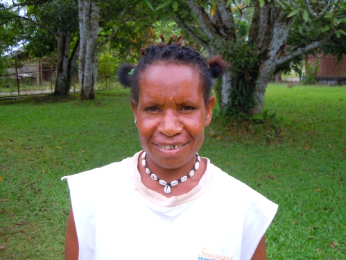 This young West Papuan woman wears her cowry necklace as many commonly do, as simple jewelry. 