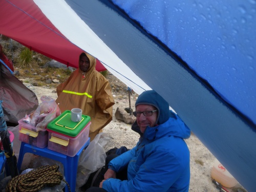 Hiding from the rain at Carstensz Base Camp!