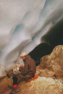 Philip Temple writing a note to leave in a cairn at the then snout of the Carstensz Glacier (now gone).